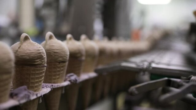 Food industry. Automation and technology. Industrial chocolate ice cream cones factory machine
