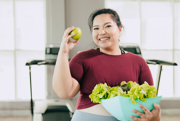 fat women happy enjoy eating green salad vegetables and apple fruit for vitamin healthcare diet...