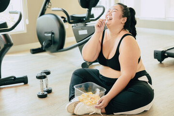 Binge Eating Disorder (BED), happy fat women laugh enjoy unstopable eating chips snack food during...