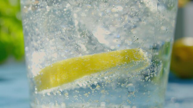 Lime Slice Floating in Fizzy Carbonated Water Glass