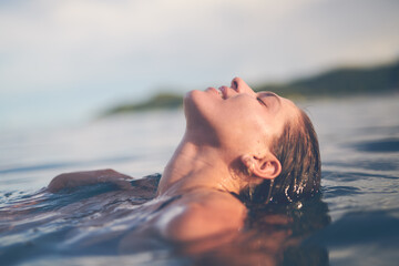 Ocean, swimming and woman with holiday, sea and relax with getaway trip, freedom and outdoor for...