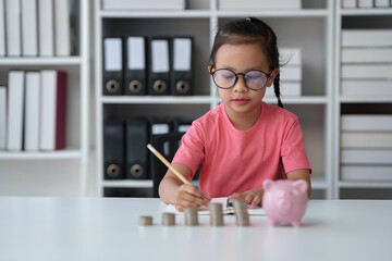 Saving money. Asian daughter wearing glasses plans to spend money in the future Family financial...
