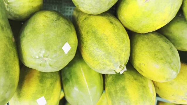green papaya tropical central america fruit in stand of local market fruit and fresh vegetable from land 