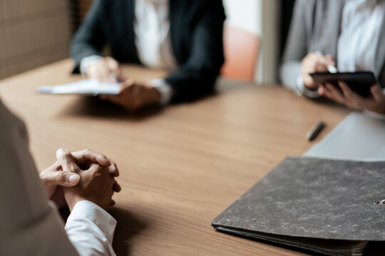 HR manager woman reading resume and asking questions with male candidate while job interviewing