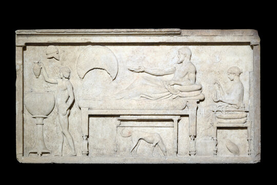 Relief depicting scenes of daily life of people in the Mediterranean on a marble slab. Exposition of ancient art at the Archaeological Museum: Istanbul, Turkey - October 19, 2023.