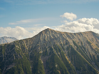 Todorka Peak in Pirin Mountains under beautiful sky and low sun lighting.