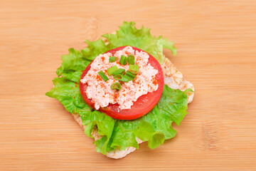Rice Cake Sandwich with Tomato, Lettuce, Fish Cream and Green Onions on Bamboo Cutting Board. Easy...