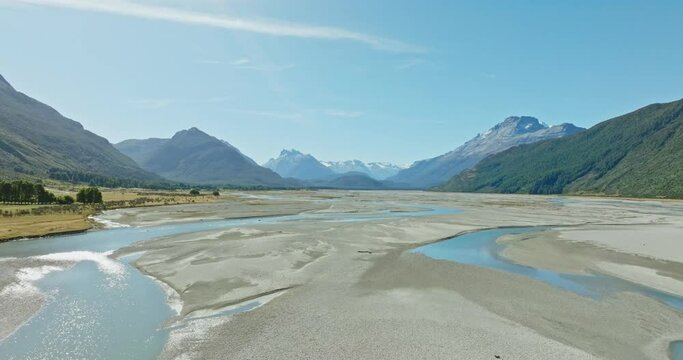 Stunning aerial flight over NZ braided river in Dart Valley towards the Southern Alps mountain ranges in Glenorchy, South Island of New Zealand Aotearoa