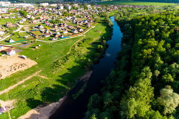 Aerial view of an urban settlement located near the river. Krivskoye, Kaluga region, Russia