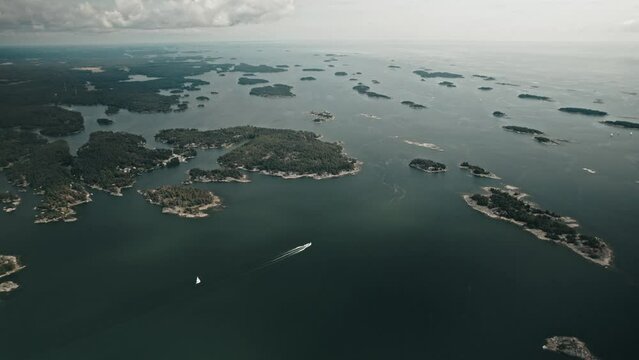 Aerial, Drone, Finnish coast with lots of islands and a boat driving through