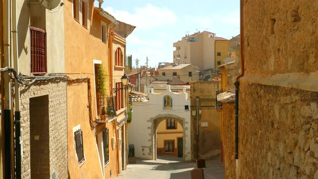 Shot of traditional old Spanish quaint village houses with narrow streets in Borriol, Spain on a sunny day.
