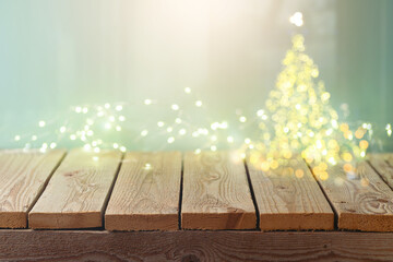 Empty wooden table over Christmas tree lights bokeh background. Christmas mock up for design and...