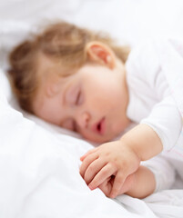Obraz na płótnie Canvas Hands, baby and kid sleeping on bed for calm break, peace and dreaming to relax at home. Tired, young child and cozy nap for newborn development, healthy childhood growth and rest in nursery room
