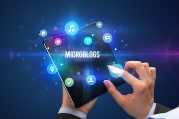 Businessman holding a foldable smartphone