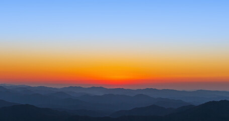 A landscape where the sun sets over the mountains. sunset