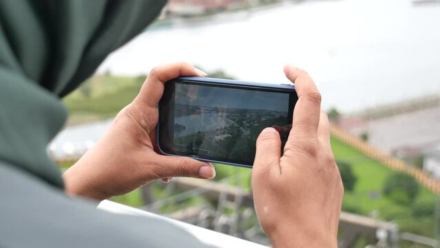 young woman taking photo with an smart phone .