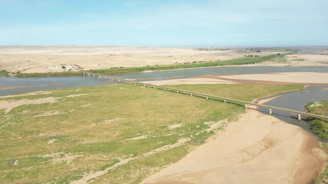 The long Ernest Oppenheimer Bridge across the Orange River connects South Africa to Namibia