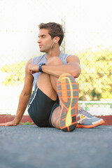 Fitness, break and man athlete in nature with earphones training for race, marathon or competition....