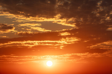 Golden sunset on the sky with clouds