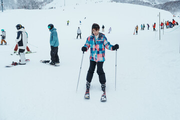 Young woman playing Ski in winter season. Snow winter activity concept