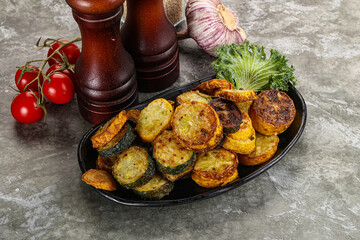 Roasted young zucchini in the plate