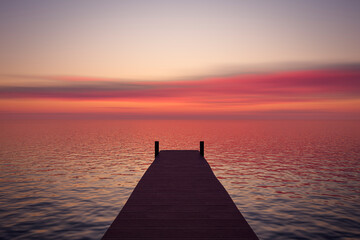 Beautiful sunset over the calm surface of the ocean.