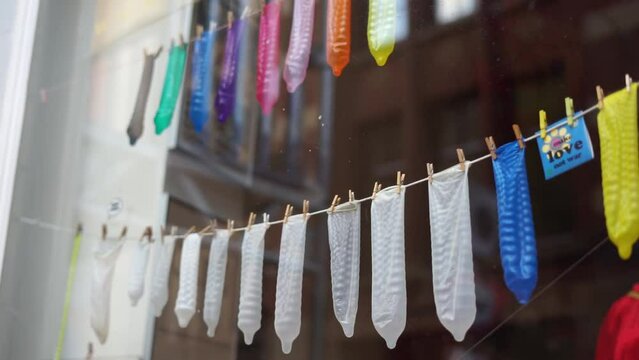 many different condoms hanging on the counter