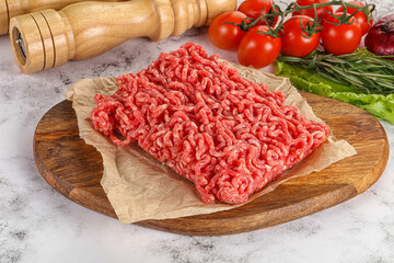 Raw minced beef meat on cutting board