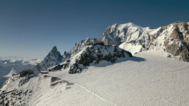 Skyway Monte Bianco cableway mountain top with mont blanc and rope team