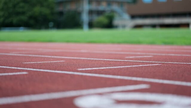 Close-up tracking shot of running track with runner training session