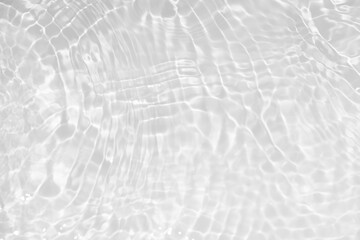 White water with ripples on the surface. Defocus blurred transparent white colored clear calm water surface texture with splashes and bubbles. Water waves with shining pattern texture background.