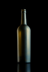 Empty open wine matte bottle on a black background. Studio shot. Vertical.