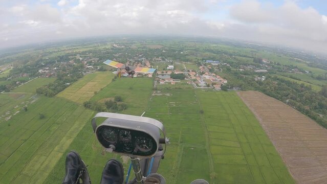 POV from cockpit of ultralight aircraft gliding from left to right