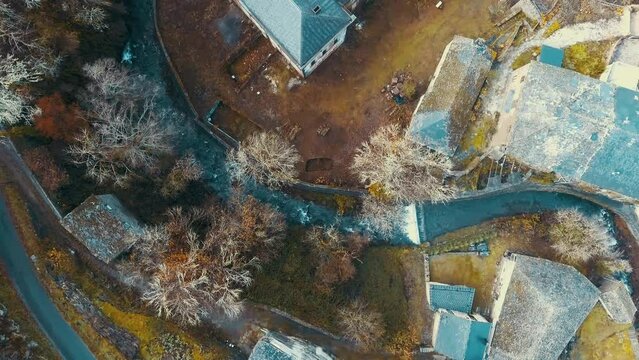 Aerial drone view filmed of an old Galician town where you can see abandoned buildings and the river that runs through the interior, showing a beautiful snapshot of what life conveyed in the towns far