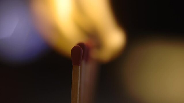 Burning matches on a row - shot in  slow motion  - macro shot on black background