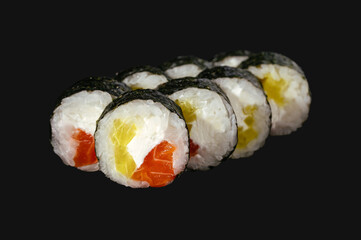 sushi roll withsalmon, daikon and cream cheese on black background.