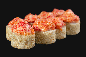 Baked spicy tuna roll on black background