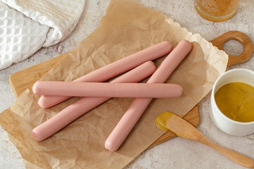 pork sausages for hot dogs on a wooden board
