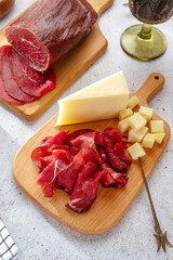 homemade beef delicatessen meat with spices cut on a wooden board