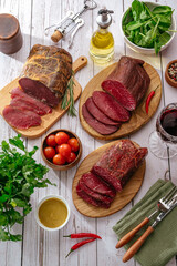 delicatessen meat with spices cut on a wooden board
