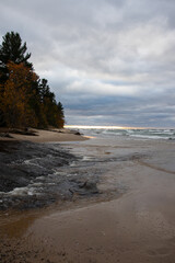 Chilly autumn sunset over the beach with incoming waves