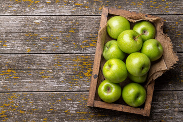 Wooden box with fresh green apples