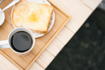 people activity concept with top view of breakfast with black coffee and bread put on wood table