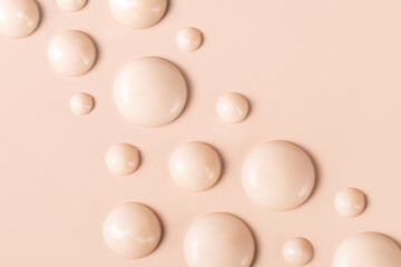 cosmetic smears drops of cream texture on beige background
