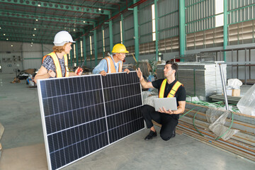 Group of workers using solar panels in warehouse. This is a freight transportation and distribution...