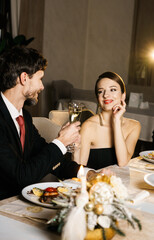 Merry Christmas! Happy family are having dinner at home. Celebration holiday and togetherness near tree.Father, mother and son at the Christmas table. Christmas and New Year concept
