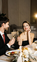 Merry Christmas! Happy family are having dinner at home. Celebration holiday and togetherness near tree.Father, mother and son at the Christmas table. Christmas and New Year concept