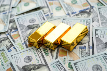  amrican dollar bills and  bar of gold as financial saving background. Rich and money
