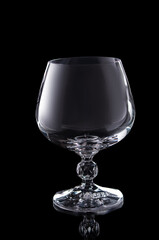 empty brendy glass isolated on black background