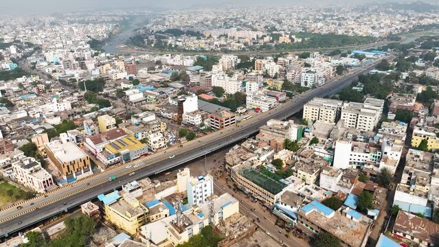 Aerial view of urban Hyderabad, India. An captivating perspective showcasing the dynamic cityscape from above, road with highway car traffic roaming through residential area.